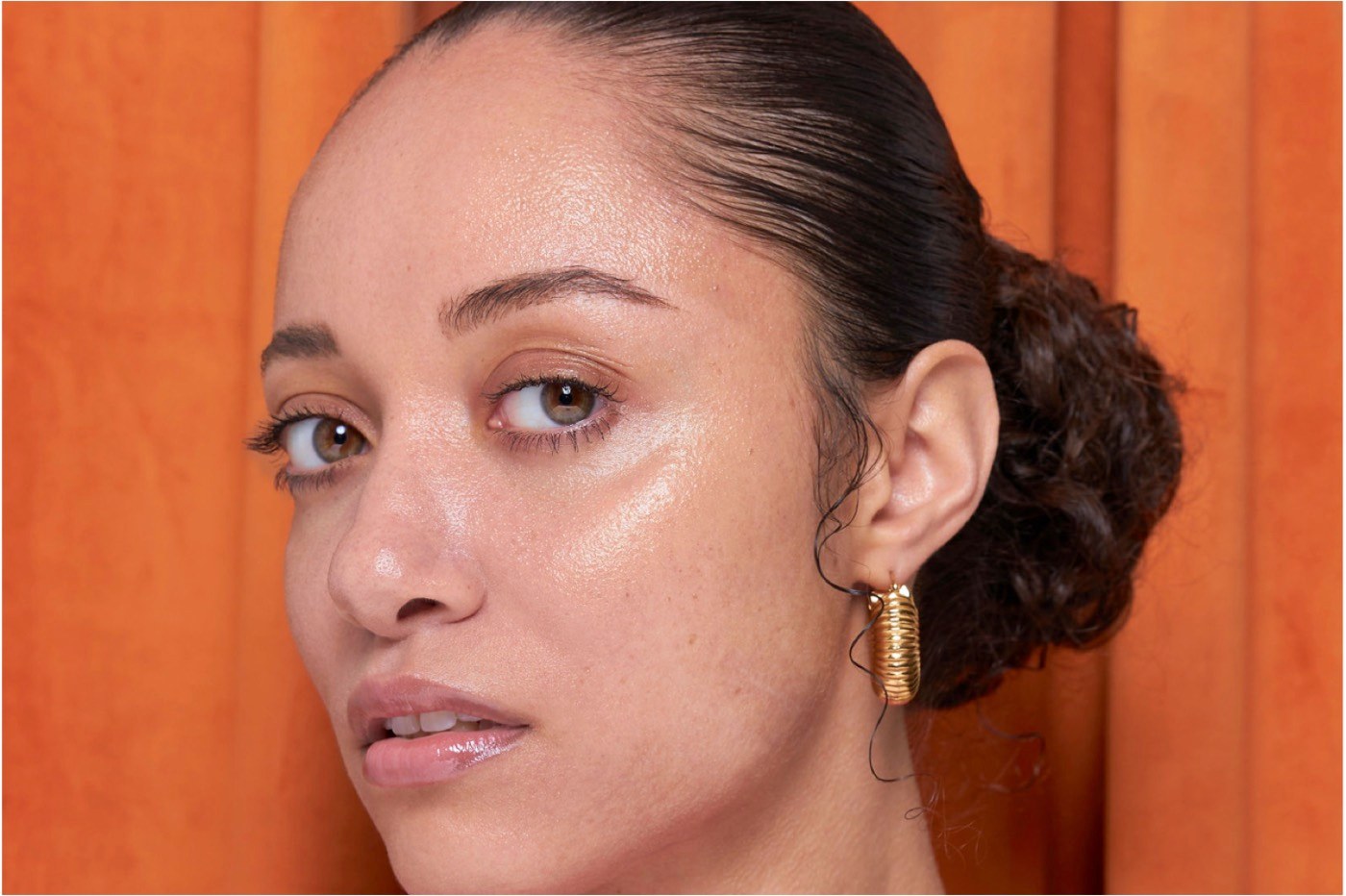 Lion Pose campaign — model portrait against orange