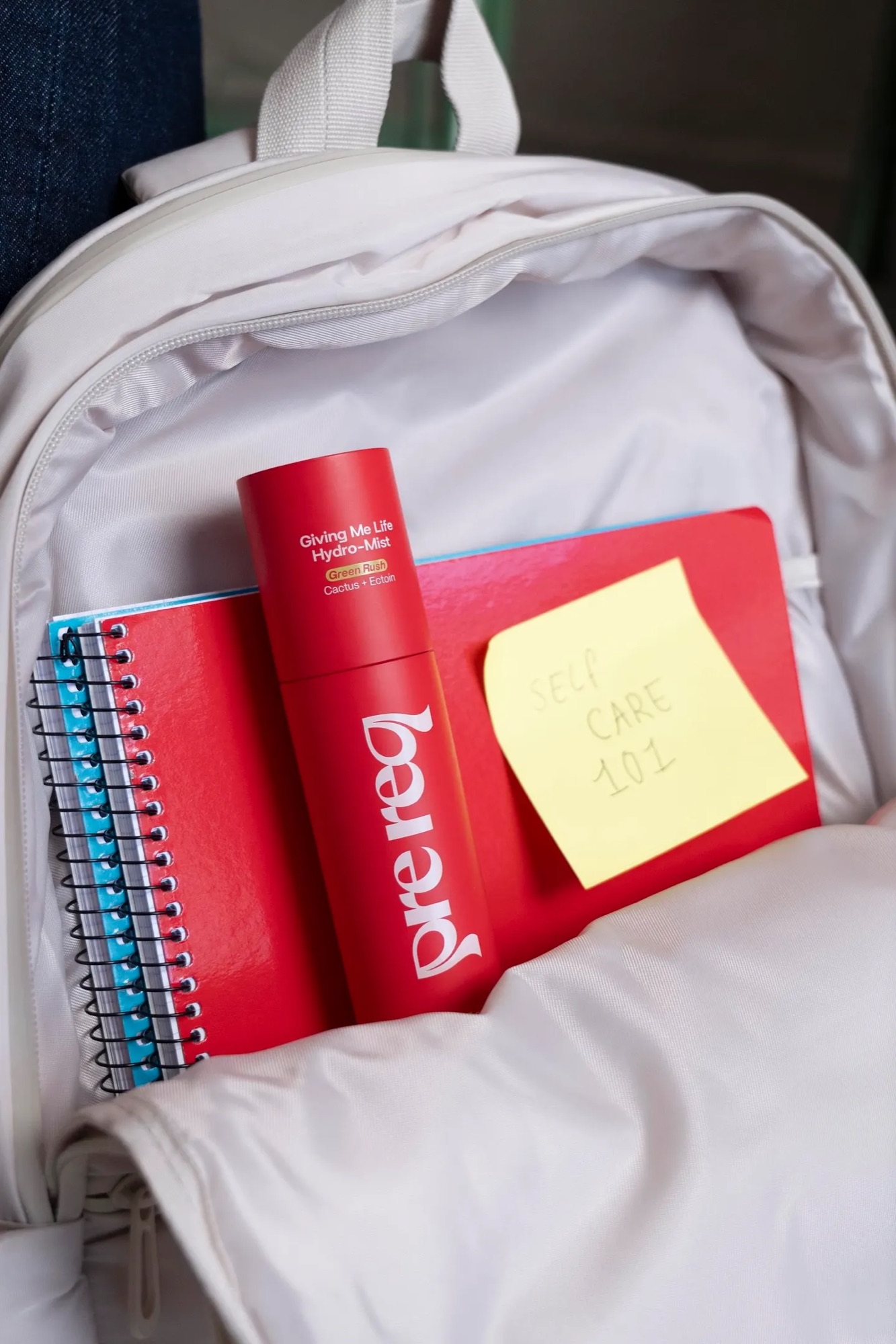 Prereq skincare tucked into a school backpack with notebooks and a post-it reading OMG YES